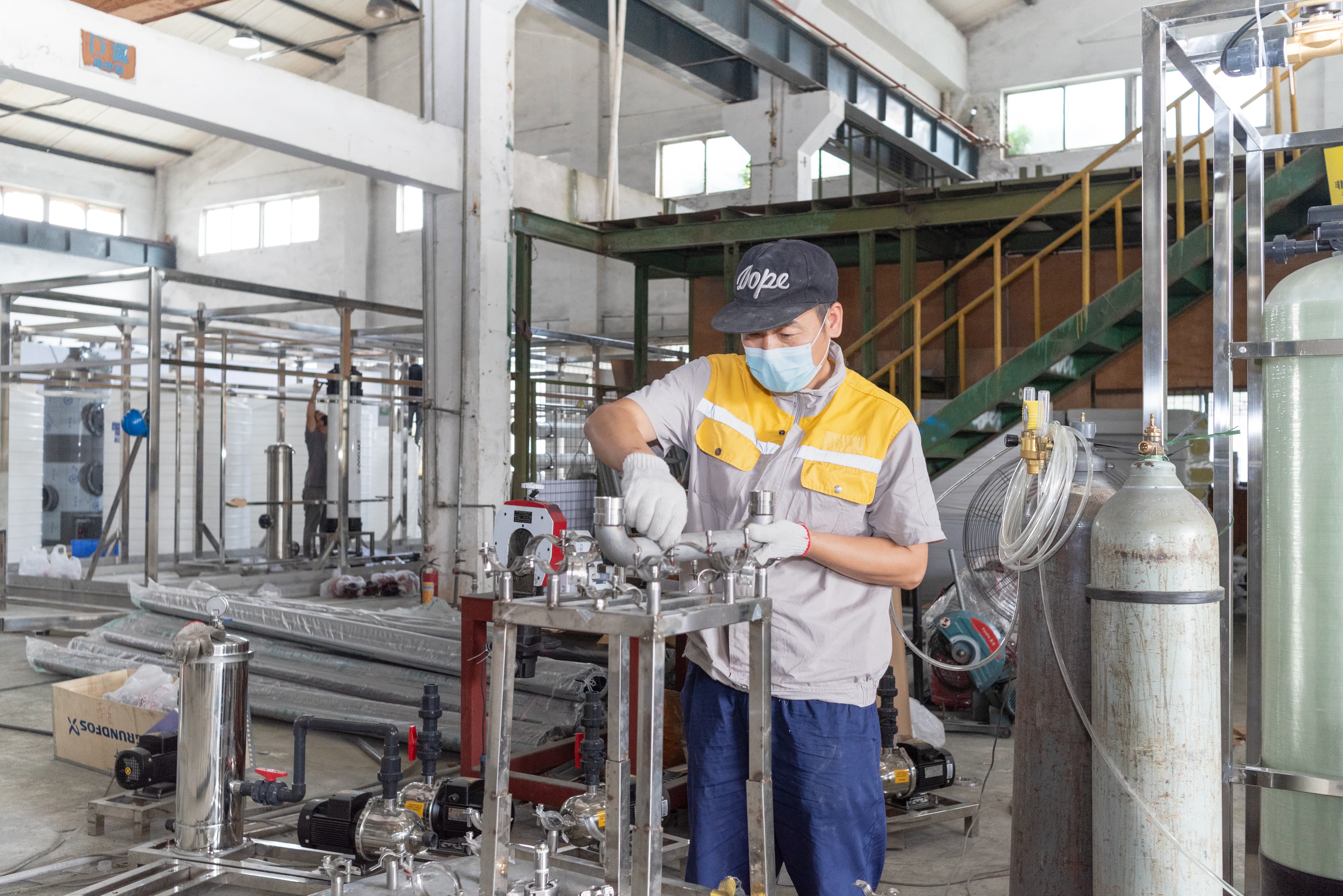 Technician assembling an industrial water-treatment system