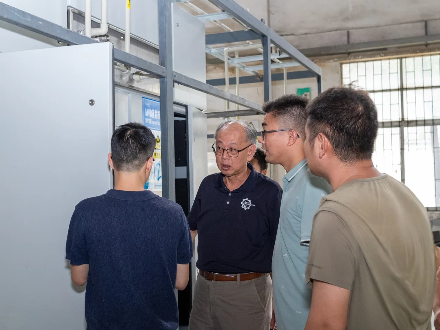 Engineers reviewing an industrial high-purity water system for battery production