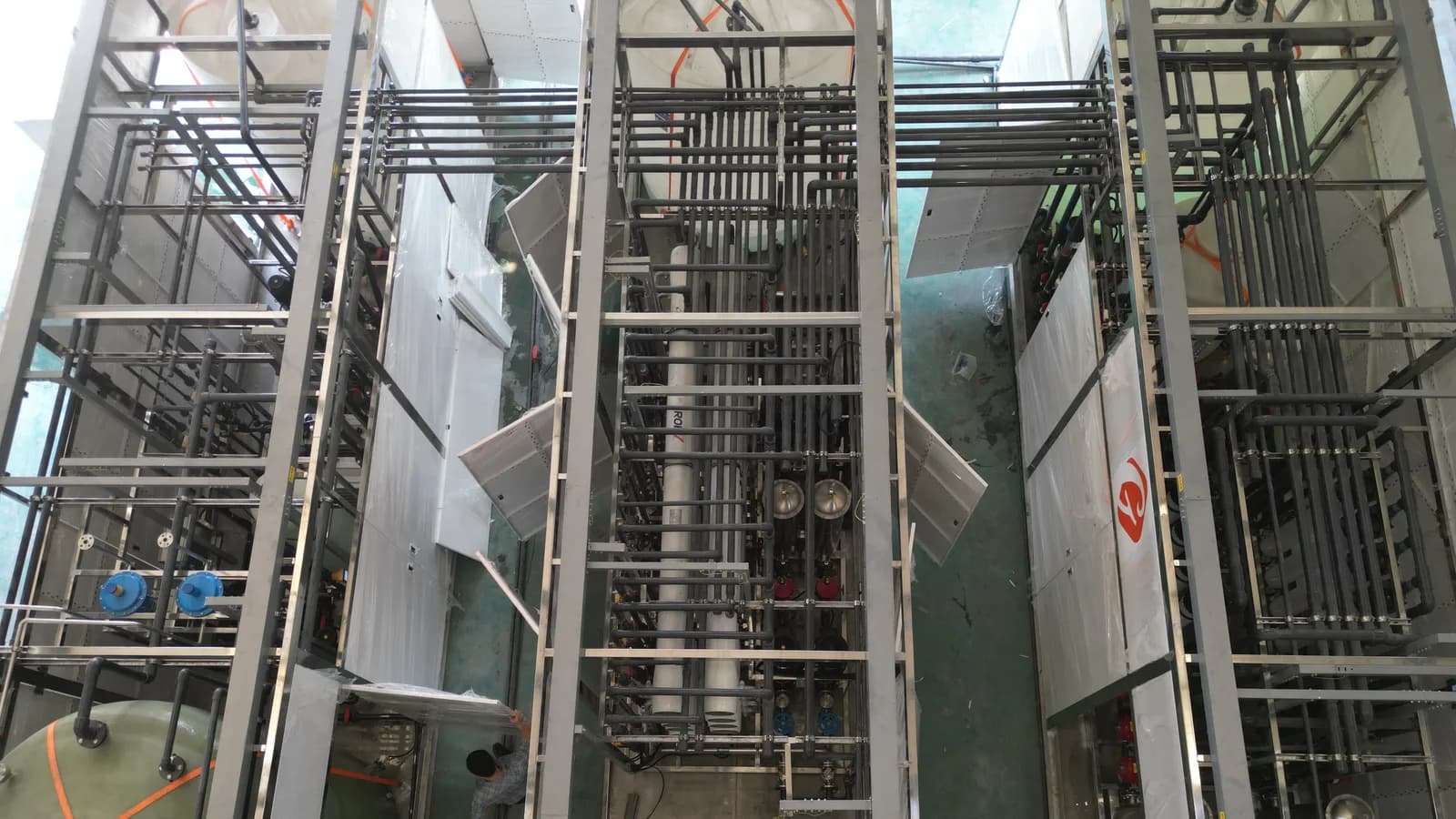 Factory assembly of an industrial pure-water treatment system with process piping
