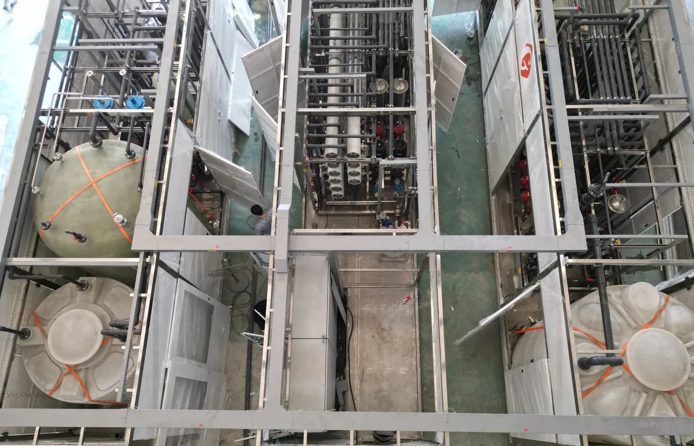 Industrial water-treatment equipment layout viewed from above during assembly